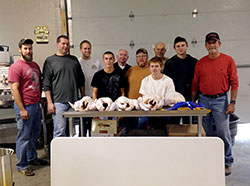 Members of St. Mary Parish in Greensburg prepare to start cooking Thanksgiving turkeys for needy families in Decatur County. Pictured, back row, from left, are Jeremiah Westerfeld, Jeremy Effing, Josh Shields, Brandon Butz, Glenn Tebbe, Ernie Stephens and Jake Stephens. Standing in the front row are Mike Mentz, Isaiah Kuntz and Larry Bishop. (Photo by Monty Shields)