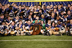 The football team of Cathedral High School in Indianapolis poses with the Indiana High School Athletic Association Class 5A trophy after their 56-7 victory over LaPorte High School in the state championship game on Nov. 29 at Lucas Oil Stadium in Indianapolis. (Submitted photo)