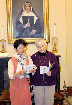 Sisters of Providence General Superior Sister Denise Wilkinson, right, reads with Anna Fan during a welcome ceremony on Nov. 13. (Submitted photo)