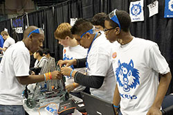 Members of the robotics team at Providence Cristo Rey High School in Indianapolis fine-tune their robot during the Robotics Championship in November. Andrew Watkins, left, Garrett Johnson, Jose Garcia and Armon Badgett are in the forefront while Ajay Pandya is partially hidden in the back. (Submitted photo)