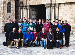 Seminarians from Bishop Simon Bruté College Seminary in Indianapolis and Saint Meinrad Seminary and School of Theology in St. Meinrad pose outside of the Church of the Holy Sepulcher in Jerusalem during a December 2014 pilgrimage to the Holy Land. Father Robert Robeson, at left, rector of Bishop Bruté, helped lead the pilgrimage. (Submitted photo)