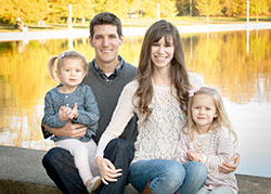 Adam and Lauren Megel of St. Bartholomew Parish in Columbus pose for a family photo with their daughters, Madelyn, left, and Abigail, in October of 2014, a few months before a great loss in their lives showed them how much they are loved. (Photo by David Bugert Photography)