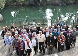 The pilgrims smile after renewing their baptismal vows in a service led by Archbishop Joseph W. Tobin along the Jordan River on Feb. 9. (Photos by Natalie Hoefer)