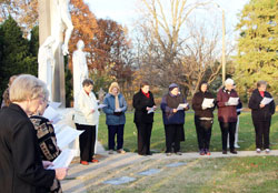 Sisters of St. Benedict at Our Lady of Grace Monastery in Beech Grove participate in an All Souls Day remembrance of their deceased sisters, on Nov. 2, 2014. Each year, the sisters gather at the cemetery to remember deceased sisters, and then the prioress prays over each grave.