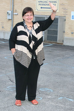 Encouraging students to live their Catholic faith has always been the main message of Joan Livingston, who is retiring after 40 years as a teacher and a principal at St. Joseph School in Shelbyville. Here, she is shown greeting students as they arrive at school one morning. (Submitted photo)