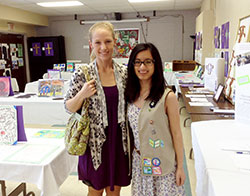 Theresa Bridge, right, invited the students of Holy Cross Central School and St. Philip Neri School to create art work that showed their love of their Catholic faith and their pride for the east side of Indianapolis. She then organized an art show as a way of creating another connection between the two faith communities after Holy Cross Parish was merged into St. Philip Neri Parish. Theresa poses in this photo with Emily Schenkenfelder, the art teacher at St. Philip Neri School. (Submitted photo)