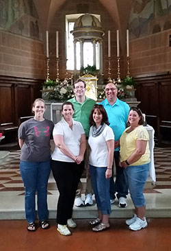 A group of educators from Roncalli High School in Indianapolis made a recent pilgrimage to Italy to learn more about their school’s namesake, Angelo Roncalli—the birth name of St. John XXIII. Part of their trip included a visit to St. Mary’s Church in Sotto il Monte, the church where St. John was baptized and served as an altar boy. Laura Armbruster, left, Beth Reel, Michelle Roberts and Terese Carson pose in the front row while Anthony Walters, left, and James Kedra stand in the back row. (Submitted photo by Chuck Weisenbach )