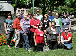 The catechists from the Archdiocese of Indianapolis who attended the St. John Bosco catechetical conference at Franciscan University of Steubenville in Steubenville, Ohio, pose on July 16, the last day of the four-day gathering. Kneeling are Lisa Whitaker, left, Manuela Johnson and Erin Jeffries. Standing are Connie Sandlin, left, Mary Wagner, Jeffrey Earl, Sandra Hartlieb, Kim Sprague, Lynelle Chamberlain, Brad Macke, Paulette Davis, Quanah Jeffries, Charlene Phillips and Gabriela Carrero. Not pictured: Denise Dubois. 
