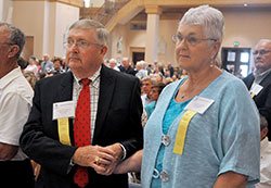 Richard and Maribeth McKaig, members of St. John the Apostle Parish in Bloomington, hold hands while renewing their wedding vows during the archdiocesan annual Golden Wedding Jubilee Mass on Aug. 23 at SS. Peter and Paul Cathedral in Indianapolis. The McKaigs and 102 other couples from across central and southern Indiana were honored during the liturgy for their faithfulness to marriage during 50 years. (Photo by Sean Gallagher) 