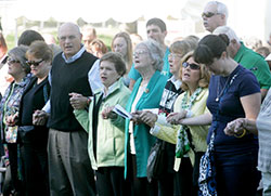 Participants in the Indy Irish Fest hold hands during the praying of the “Our Father” at the Sunday Mass, a tradition that begins the last day of the festival which is on Sept. 17-20 this year at Military Park in Indianapolis. (Submitted photo) 