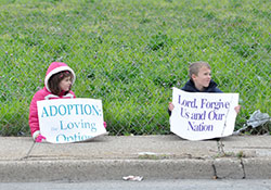 Rose and Luke Yunger, children of Sara and Joseph Yunger of All Saints Parish in Dearborn County, hold signs during the Life Chain on North Meridian Street in Indianapolis on Oct. 5, 2014. (Criterion file photo by Natalie Hoefer)