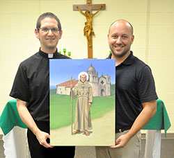 Father Eric Augenstein and Michael McCarthy hold a painting of St. Junipero Serra in the St. Alphonsus Liguori Chapel in the Archbishop Edward T. O’Meara Catholic Center in Indianapolis. The painting, created by McCarthy, was commissioned by the archdiocesan Vocations Office and the Indianapolis Serra Club. It will be used on prayer cards and posters to promote priesthood and religious vocations. (Photo by Sean Gallagher)