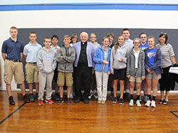 Father Eckstein is pictured with the eighth-grade class at St. Nicholas School and Debbie Gregg, who teaches seventh- and eighth-grade English and language arts, and eighth-grade social studies and religion. (Submitted photo)