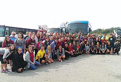 Young adults, college students and missionaries who traveled with Father Rick Nagel, pastor of St. John the Evangelist Parish and chaplain at Indiana University-Purdue University, both in Indianapolis, pose for a group photo on Sept. 25 on their way to the World Meeting of Families in Philadelphia. (Photo by George Kane) 