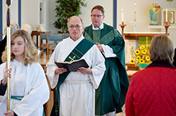 Altar server Cami Swaner, left, Deacon Steven Gretencord and Father Joseph Feltz, sacramental minister, process out of Sacred Heart Church in Terre Haute at the end of a Mass celebrated on Oct. 18. Like all permanent deacons, Deacon Gretencord balances his ministry between duties at the parish and serving in the community. (Submitted photo)