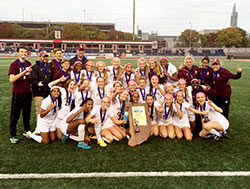 Members of the girls’ soccer team at Brebeuf Jesuit Preparatory School in Indianapolis pose with the state championship trophy. They beat Penn High School in Mishawaka on Oct. 31 by a 2-1 score. (Submitted photo)