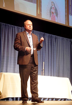 Businessman and author Randy Hain addresses the 500 men in attendance at the annual Indiana Catholic Men’s Conference in Indianapolis on Oct. 31. “Never forget the life-changing power of saying ‘yes’ to God,” Hain said. (Photo by Mike Krokos)