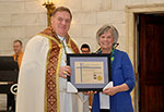 Archbishop and women with certificate