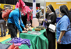 Youths from the St. Cloud, Minn., Diocese play a Catholic trivia game on Nov. 19 with Felician Sisters Eliana Remiszewewska, left, and Mary Beth Bromer in the Indiana Convention Center in Indianapolis during the National Catholic Youth Conference. (Photo by Sean Gallagher)