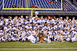 Bishop Chatard High School players and coaches are pictured with the Class 3A state football trophy on Nov. 27 at Lucas Oil Stadium in Indianapolis. (Submitted photo by Emily Smith)