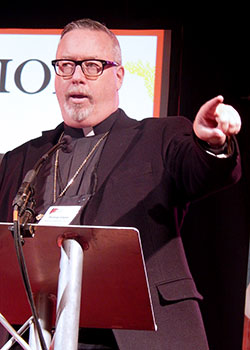 Bishop Christopher J. Coyne addresses young adults on Nov. 21 during the National Catholic Collegiate Conference in Indianapolis. (Photo by Mike Krokos)