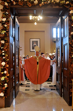 “This is the Lord’s gate: let us enter through it and obtain mercy and forgiveness,” Archbishop Joseph W. Tobin declares as he opens the doors of mercy at SS. Peter and Paul Cathedral in Indianapolis on Dec. 13. (Photo by Natalie Hoefer)