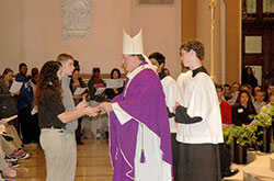 Archbishop Joseph W. Tobin accepts offertory gifts during a Mass for high school seniors from across the archdiocese on Dec. 2 at SS. Peter and Paul Cathedral in Indianapolis. (Photo by John Shaughnessy)