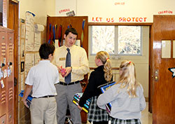 Religion teacher Daniel Klee chats with his students at Christ the King School in Indianapolis. (Submitted photo)