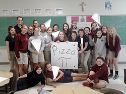 A team of teachers at St. Barnabas School in Indianapolis has been chosen for a special three-year program at the University of Notre Dame that focuses on helping teachers inspire student learning in the areas of science, technology, engineering and math (STEM). Here, math teacher Doug Bauman poses with his students after they worked to create new pizza boxes—a challenge that Bauman made after he ordered an extra-large pizza that was placed in a box that wouldn’t fit in his car. (Submitted photo)
