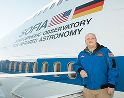 Troy Cockrum poses for a photo near a NASA jetliner in November of 2015. The director of innovative teaching at St. Therese of the Infant Jesus (Little Flower) School in Indianapolis, Cockrum was one of 28 educators from across the country who was chosen to fly on NASA’s Stratospheric Observatory for Infrared Astronomy (SOFIA), the world’s largest flying telescope. (Submitted photo)