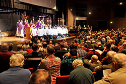 Hundreds of Catholic men kneel in prayer on March 5 at East Central High School in St. Leon while principal celebrant Archbishop Joseph W. Tobin and several concelebrating priests pray the eucharistic prayer during a Mass. The liturgy was part of the first “E6 Catholic Men’s Conference,” which was organized by men who are parishioners of All Saints Parish in Dearborn County. (Photos by Sean Gallagher)