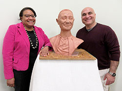 Dr. Cecilia A. Moore, featured speaker, and sculptor Guy Tedesco pose with Tedesco’s clay bust of Cardinal Joseph E. Ritter, which was unveiled at the Cardinal Ritter House Irish coffee event in New Albany on March 14. The “study bust” will later be cast in bronze. (Photo by Patricia Happel Cornwell)
