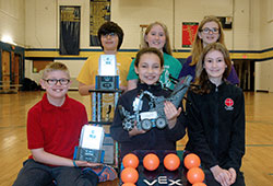 A robotics team at St. Thomas Aquinas School in Indianapolis is the only one from a Catholic school in Indiana to earn a place in the 2016 Vex Robotics World Championship in Louisville, Ky., on April 20-23. Members of the team in the first row are Bradley Basile, left, Maggie Gonzalez (holding the team robot “Fluffy Sylvester”) and Julia Dugan. Team members in the second row are Jackson Herrera, left, Grace Gerdenich and Maggie Timpe. (Photo by John Shaughnessy)