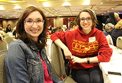 Jennifer Conley, left, and her sister, Jessica DeFrench, enjoy time together during the Indiana Catholic Women’s Conference on March 19. Conley sees a miraculous connection between a healing service at last year’s conference and the recent birth of her daughter, Mariella Faustina. The baby’s first name, an Italian variation of Mary, also means “wished-for child,” while her middle name is in honor of St. Faustina Kowalska, who introduced the world to the Divine Mercy image and devotion. (Photo by Victoria Arthur)