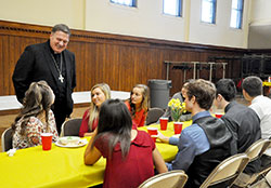 Archbishop Joseph W. Tobin chats with a few “A Promise to Keep” mentors from Roncalli High School during a luncheon at the Archbishop Edward T. O’Meara Catholic Center in Indianapolis on April 14. (Photos by Natalie Hoefer)