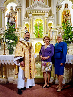 Father Aaron Pfaff, pastor of St. Joseph Parish in Shelbyville, poses with newly confirmed Catholic Edy Ballard and her sponsor, Carol McElroy, in St. Joseph Church after the parish’s Easter Vigil Mass on March 26. (Submitted photo)