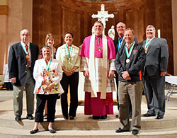 Seven members of the archdiocese received the Catholic Youth Organization’s highest honor—the St. John Bosco Medal—from Archbishop Joseph W. Tobin during an awards ceremony at SS. Peter and Paul Cathedral in Indianapolis on May 4. Medal recipients Elaine Alhand and Mark Gumbel are in the first row. In the second row, posing with Archbishop Tobin are Bill Sylvester, left, Patty Koors, M.J. Stallings, Joe Matis and Dan Lutgring. (Submitted photo by Christine Metzger)