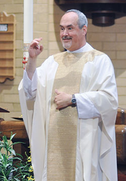 Oblates of St. Francis de Sales Father Michael Depcik, a deaf priest from the Archdiocese of Detroit, signs his homily in American Sign Language during a special Mass for deaf Catholics of central and southern Indiana at St. Matthew the Apostle Church in Indianapolis on April 20. (Photo by Natalie Hoefer)