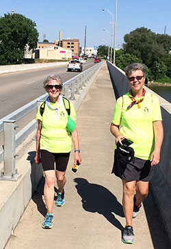 Bev Watt, left, and Monica Robinson smile as they cross the Wabash River on June 10 while on a walking pilgrimage to visit the shrine of St. Theodora Guérin in her shrine at Saint Mary-of-the-Woods. (Submitted photo by Jim Recasner)