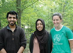 In early August, the archdiocese’s Catholic Youth Organization (CYO) camp in Brown County became the setting for about 150 Muslim youths from across the country to enjoy a week of swimming, canoeing, climbing and learning about their faith. It also became an opportunity for members of the two faiths to learn from each other. Here, two advisers of the Muslim Youth of North America camp, Uzair Siddiqui, left, and Fariha Hossain, pose for a photo with Anne Taube, assistant camp director of the CYO’s Camp Rancho Framasa. (Photo by John Shaughnessy)
