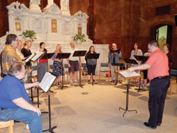 Andrew Motyka, director of archdiocesan and cathedral liturgical music, leads members of Vox Sacra during practice on Aug. 18 at SS. Peter and Paul Cathedral in Indianapolis. The group will perform its first public concert on Sept. 8 at the cathedral. (Photo by Mike Krokos)