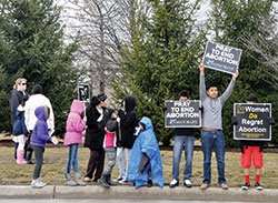 Participants in the 2015 40 Days for Life midpoint rally hold pro-life signs on March 14 outside the Planned Parenthood abortion facility in Indianapolis. (Criterion file photo by Natalie Hoefer)
