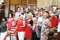 Massgoers hold hands during an Aug. 20 liturgy at St. Bartholomew Church in Columbus that celebrated the 175th anniversary of the founding of the Seymour Deanery faith community. (Submitted photo)
