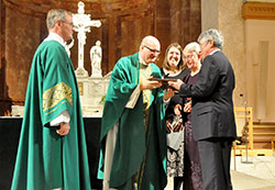 Deacon Michael Braun, left, and archdiocesan Office of Pro-Life and Family Life director Rebecca Niemerg, center, look on as Msgr. William F. Stumpf, vicar general, presents Ann and Jim Recasner with the 2016 Archbishop O’Meara Respect Life Award during the Respect Life Sunday Mass at SS. Peter and Paul Cathedral in Indianapolis on Oct. 2. (Photo by Natalie Hoefer)