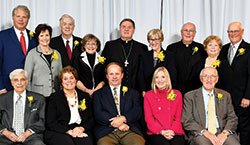 Eighteen people were honored for their contributions to the Mother Theodore Catholic Academies in Indianapolis during a 10-year anniversary celebration on Oct. 27. Seated from left are Richard Ruwe, Connie Zittnan, George Zittnan, Catherine Elder and Tim McGinley. Standing from left are Art and Ann Wilmes (accepting for Archbishop Emeritus Daniel M. Buechlein), William Drew, Jane Drew, Cardinal-designate Joseph W. Tobin, Annette “Mickey” Lentz, Msgr. Joseph Schaedel, Carole Watt and Tony Watt. Honorees not pictured are Marc and Jennifer Konesco, Charles and Jacqueline Pechette, Bill and Eileen Polian, and Jane McGinley. (Photo by Rob Banayote)