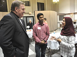 Cardinal-designate Joseph W. Tobin, archbishop of Indianapolis, speaks with Rabia Khan, information technology coordinator for the Plainfield-based Islamic Society of North America, and her son Uzair Khan after a Catholic-Muslim panel discussion on Oct. 19 at Sacred Heart of Jesus Parish in Indianapolis. (Photo by Sean Gallagher)