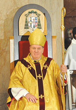 Archbishop Joseph W. Tobin sits in the new cathedra at SS. Peter and Paul Cathedral in Indianapolis for the first time during the Dec. 3, 2012, Mass when he was installed as the sixth archbishop of Indianapolis. (Criterion file photo by Mary Ann Garber)