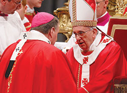 Pope Francis greets Archbishop Joseph W. Tobin of Indianapolis after presenting him with a pallium during a Mass marking the feast of Sts. Peter and Paul in St. Peter’s Basilica at the Vatican on June 29, 2013. The pope presented woolen palliums to 34 archbishops during the liturgy. (CNS file photo)