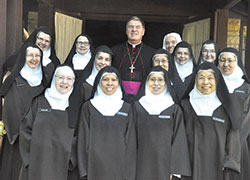Archbishop Joseph W. Tobin poses with the Discalced Carmelite nuns of the Monastary of St. Joseph in Terre Haute on Oct. 10, 2015, after celebrating a Mass with them in honor of the 500th anniversary of the birth of St. Teresa of Avila, the foundress of the their religious order. (File photo by Sean Gallagher) 