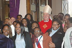 Cardinal Joseph W. Tobin poses for a photo with members of the senior class of Providence Cristo Rey High School in Indianapolis following a Mass he celebrated for high school seniors from across the archdiocese on Nov. 30 at SS. Peter and Paul Cathedral in Indianapolis. (Photo by John Shaughnessy) 
